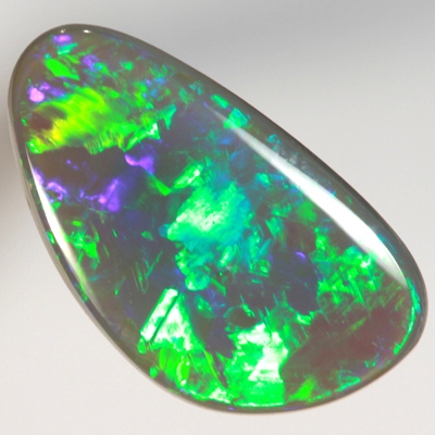 SOLID BLACK OPAL Neon turquoise and green in large rolling flashes. SEE VIDEO